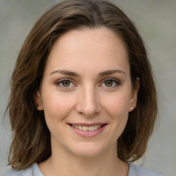 Joyful white young-adult female with medium  brown hair and green eyes