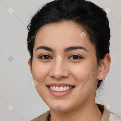 Joyful latino young-adult female with short  brown hair and brown eyes