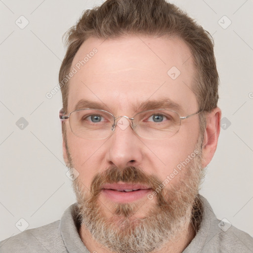 Joyful white adult male with short  brown hair and grey eyes