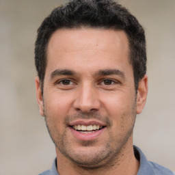 Joyful white young-adult male with short  black hair and brown eyes