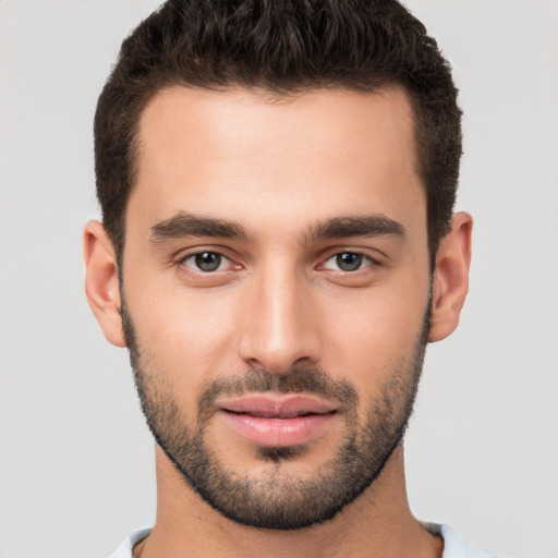 Joyful white young-adult male with short  brown hair and brown eyes