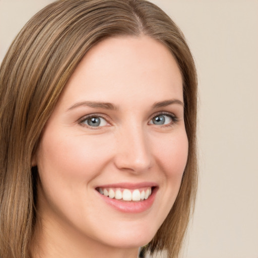 Joyful white young-adult female with long  brown hair and green eyes