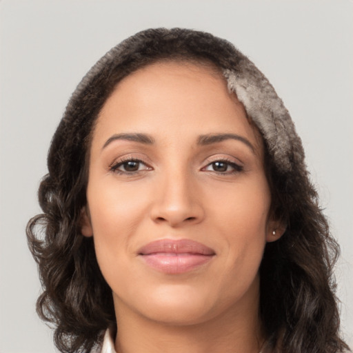 Joyful latino young-adult female with long  brown hair and brown eyes