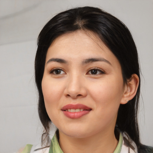 Joyful asian young-adult female with medium  black hair and brown eyes