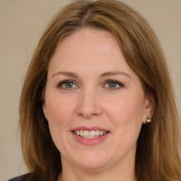 Joyful white adult female with long  brown hair and brown eyes