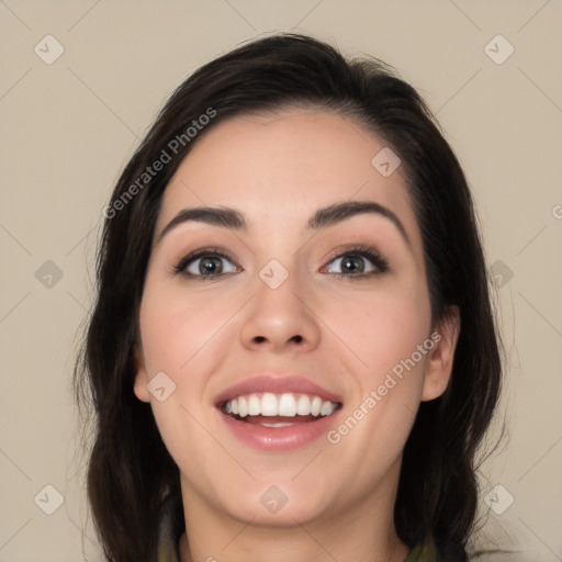 Joyful white young-adult female with long  black hair and brown eyes