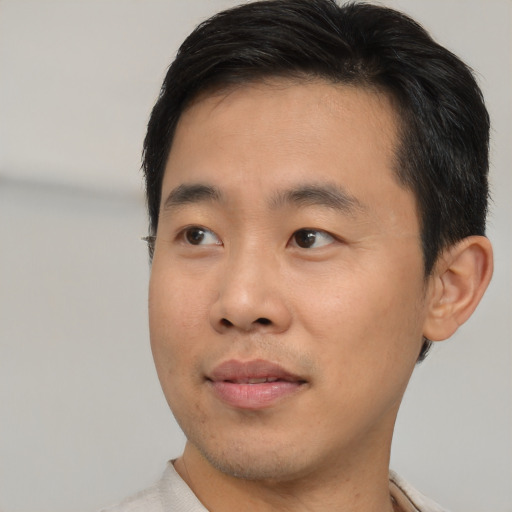 Neutral asian young-adult male with short  brown hair and brown eyes