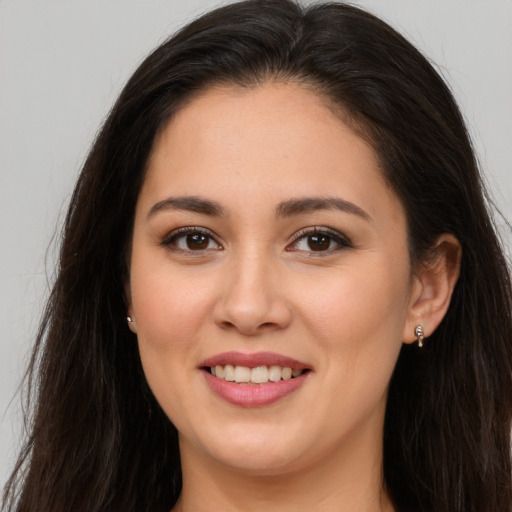 Joyful white young-adult female with long  brown hair and brown eyes