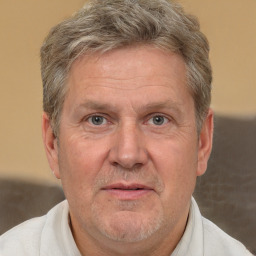 Joyful white middle-aged male with short  gray hair and brown eyes