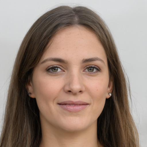 Joyful white young-adult female with long  brown hair and grey eyes