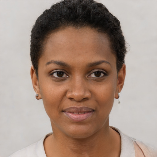 Joyful black young-adult female with short  black hair and brown eyes