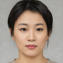 Neutral asian young-adult female with medium  brown hair and brown eyes