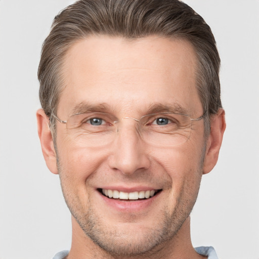 Joyful white adult male with short  brown hair and grey eyes