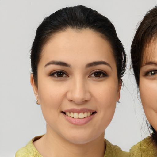Joyful asian young-adult female with medium  brown hair and brown eyes