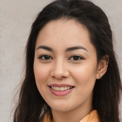 Joyful asian young-adult female with long  brown hair and brown eyes