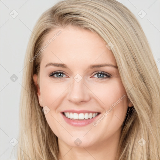 Joyful white young-adult female with long  brown hair and blue eyes