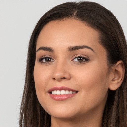 Joyful white young-adult female with long  brown hair and brown eyes