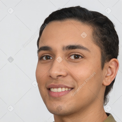 Joyful white young-adult male with short  black hair and brown eyes