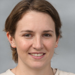 Joyful white young-adult female with medium  brown hair and grey eyes