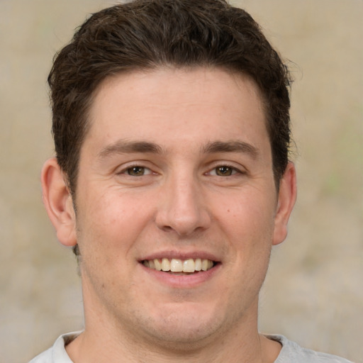 Joyful white adult male with short  brown hair and brown eyes