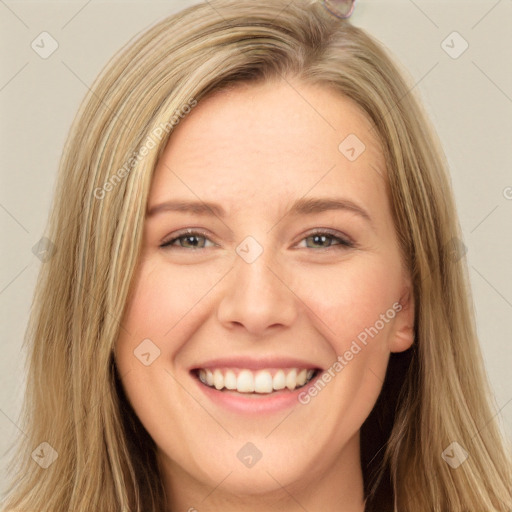 Joyful white young-adult female with long  brown hair and brown eyes