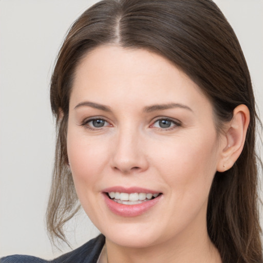 Joyful white young-adult female with long  brown hair and grey eyes