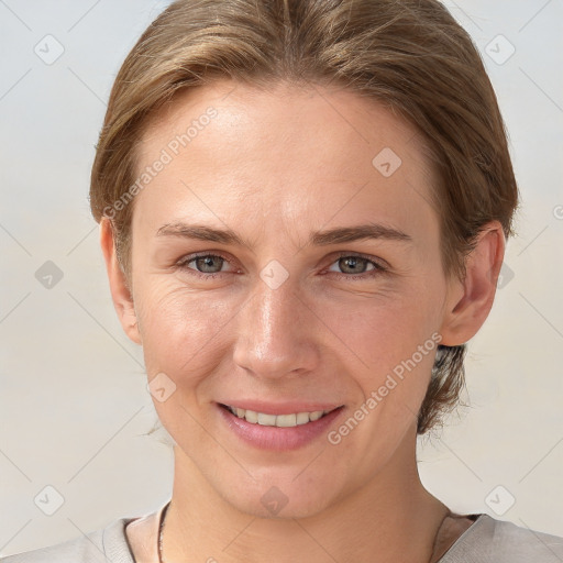 Joyful white young-adult female with short  brown hair and grey eyes