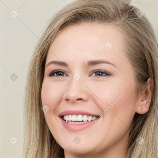 Joyful white young-adult female with long  brown hair and grey eyes