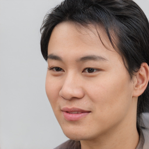 Joyful asian young-adult female with short  brown hair and brown eyes
