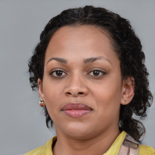 Joyful black young-adult female with medium  brown hair and brown eyes
