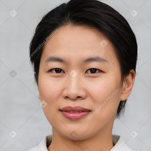 Joyful asian young-adult female with short  brown hair and brown eyes