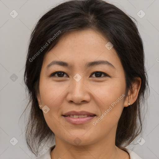 Joyful asian adult female with medium  brown hair and brown eyes