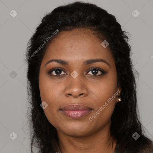 Joyful black young-adult female with long  brown hair and brown eyes