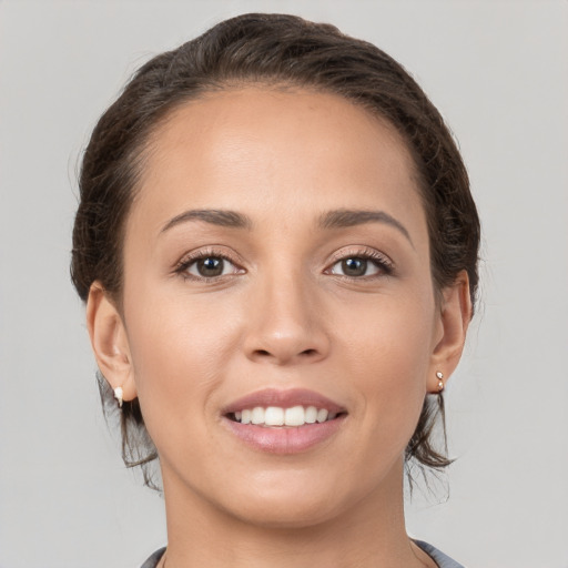 Joyful white young-adult female with medium  brown hair and brown eyes