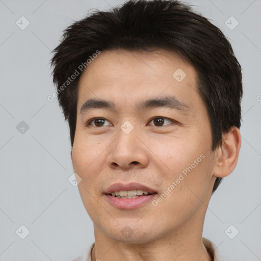 Joyful asian young-adult male with short  brown hair and brown eyes