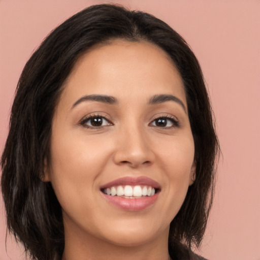 Joyful white young-adult female with long  brown hair and brown eyes