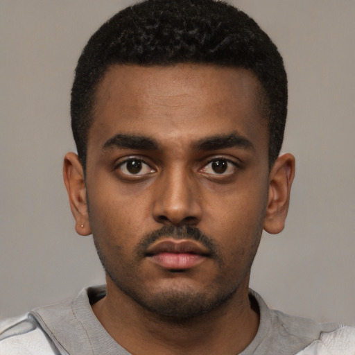 Neutral latino young-adult male with short  black hair and brown eyes