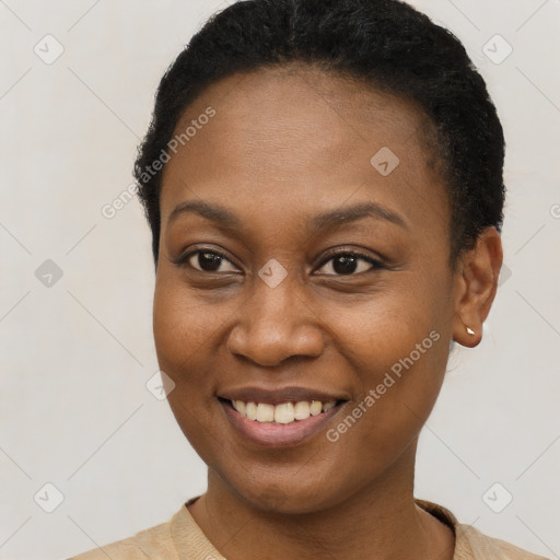 Joyful black young-adult female with short  brown hair and brown eyes