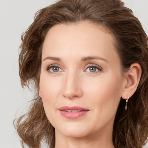 Joyful white young-adult female with medium  brown hair and green eyes