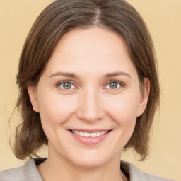 Joyful white young-adult female with medium  brown hair and grey eyes