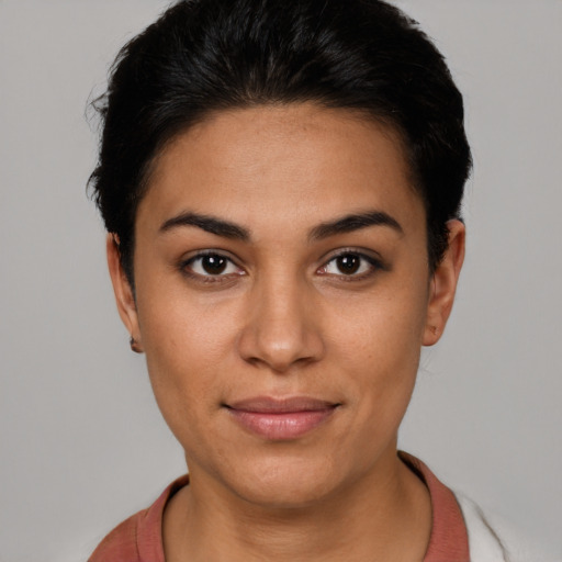 Joyful latino young-adult female with short  black hair and brown eyes