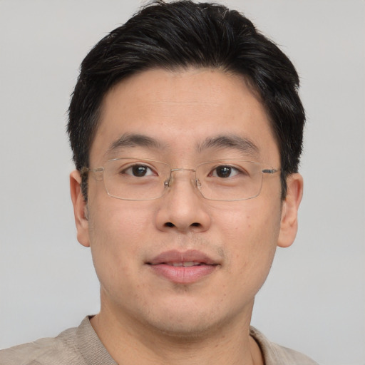 Joyful asian young-adult male with short  brown hair and brown eyes