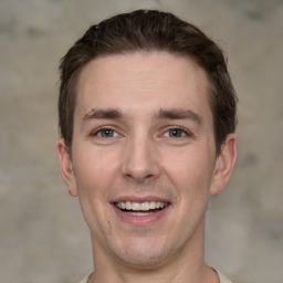 Joyful white adult male with short  brown hair and grey eyes