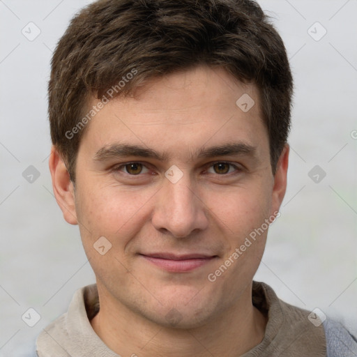 Joyful white young-adult male with short  brown hair and grey eyes