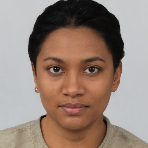 Joyful latino young-adult female with short  black hair and brown eyes