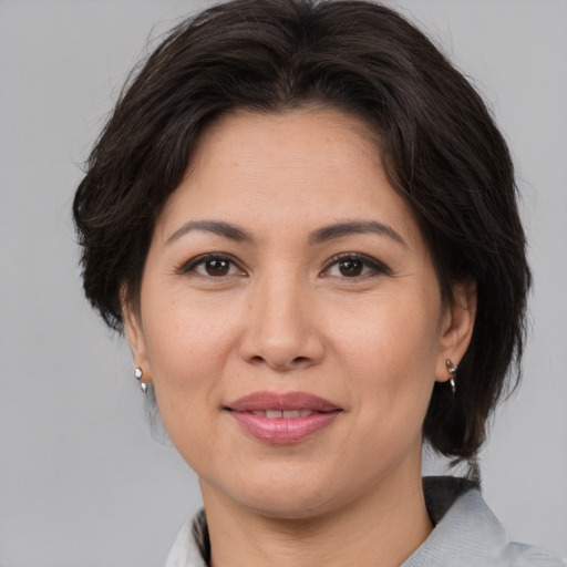 Joyful white adult female with medium  brown hair and brown eyes