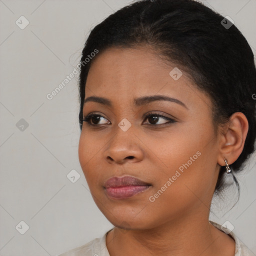 Joyful black young-adult female with long  brown hair and brown eyes