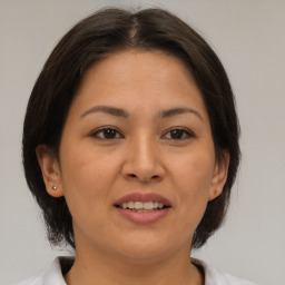 Joyful latino young-adult female with medium  brown hair and brown eyes