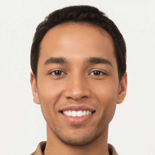 Joyful latino young-adult male with short  black hair and brown eyes