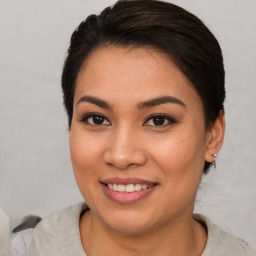 Joyful asian young-adult female with short  brown hair and brown eyes